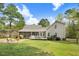 Large backyard with a screened-in porch, deck, fire pit, and a house with gray siding at 83 Wahoo Dr, Clayton, NC 27520