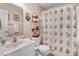 Neutral bathroom featuring a shower with floral curtain and a matching vanity with a white sink at 83 Wahoo Dr, Clayton, NC 27520