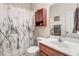 Cozy bathroom with seashell themed shower curtain and cabinet over toilet at 83 Wahoo Dr, Clayton, NC 27520