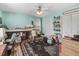 Bright bedroom with blue walls, a ceiling fan, and built-in shelving above a counter at 83 Wahoo Dr, Clayton, NC 27520