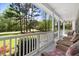 Relaxing covered front porch with comfortable wicker chairs to enjoy the views at 83 Wahoo Dr, Clayton, NC 27520