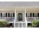 Inviting front porch with classic railings and decorative seating creates a welcoming entrance at 83 Wahoo Dr, Clayton, NC 27520