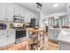 Spacious kitchen with white cabinets, stainless steel appliances, and view into dining area at 83 Wahoo Dr, Clayton, NC 27520