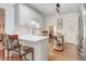 Modern kitchen with white cabinets, stainless steel appliances, and an eat-in island at 83 Wahoo Dr, Clayton, NC 27520