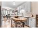 Open kitchen with white cabinets, stainless steel appliances, and a breakfast nook in view at 83 Wahoo Dr, Clayton, NC 27520