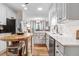Well-lit kitchen with white cabinetry, stainless steel appliances, and adjacent breakfast nook at 83 Wahoo Dr, Clayton, NC 27520