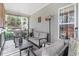 Relaxing screened porch with gray furnishings and a window overlooking the backyard at 83 Wahoo Dr, Clayton, NC 27520