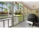 Screened porch with grill, ceiling fan, and view of the fenced backyard at 83 Wahoo Dr, Clayton, NC 27520