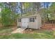 Exterior view of a storage shed with white doors, windows, and a ramp for access at 83 Wahoo Dr, Clayton, NC 27520