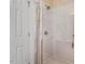 A glass-enclosed shower features white tiling and modern fixtures at 83 Wahoo Dr, Clayton, NC 27520