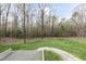 Lush backyard with stone pathway and wooded backdrop, perfect for enjoying nature at 932 Gynnis Creek Dr, Moncure, NC 27559