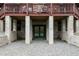 Basement entrance with concrete supports and a green door, providing access to the lower level at 932 Gynnis Creek Dr, Moncure, NC 27559