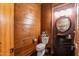 Rustic powder room featuring wooden walls, a barrel vanity, and unique decorative touches at 932 Gynnis Creek Dr, Moncure, NC 27559