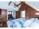 Charming bedroom features wood paneling, a decorative rug, and an adjacent office area with natural light at 932 Gynnis Creek Dr, Moncure, NC 27559