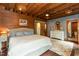 Charming bedroom featuring wood walls, a comfortable bed, and a stylish dresser with mirror at 932 Gynnis Creek Dr, Moncure, NC 27559