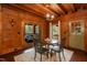 Cozy dining room features a round table with seating for four and views of the outdoor patio at 932 Gynnis Creek Dr, Moncure, NC 27559