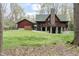 Home exterior featuring manicured lawn and wooded background at 932 Gynnis Creek Dr, Moncure, NC 27559