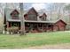 Charming log home with a covered front porch, dormer windows, and a matching two-car garage at 932 Gynnis Creek Dr, Moncure, NC 27559