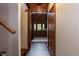 Inviting foyer with hardwood floors, wood trim, and natural light streaming through the glass paneled front door at 932 Gynnis Creek Dr, Moncure, NC 27559