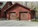Exterior shot of a spacious two-car garage with carriage doors and a well maintained gravel driveway at 932 Gynnis Creek Dr, Moncure, NC 27559