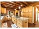 Open concept kitchen features a large island, stainless appliances, custom cabinets and hardwood floors at 932 Gynnis Creek Dr, Moncure, NC 27559