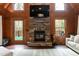 Open living room with stone fireplace, TV and access to an outdoor deck at 932 Gynnis Creek Dr, Moncure, NC 27559
