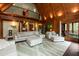 Spacious living room with wooden ceilings, large windows, and comfortable, modern furnishings at 932 Gynnis Creek Dr, Moncure, NC 27559