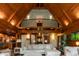 Open-concept living room featuring wood ceilings, a large sofa, and seamless access to the kitchen at 932 Gynnis Creek Dr, Moncure, NC 27559