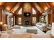 Living room with vaulted wood ceiling, stone fireplace, TV, hardwood floors and plenty of seating at 932 Gynnis Creek Dr, Moncure, NC 27559
