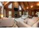 Spacious living room features a stone fireplace, TV, wood ceiling and large windows at 932 Gynnis Creek Dr, Moncure, NC 27559