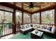 Inviting screened patio with comfortable seating, ceiling fan, and views of the surrounding nature at 932 Gynnis Creek Dr, Moncure, NC 27559