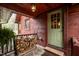 Charming porch with firewood storage and a light green front door, offering a cozy welcome at 932 Gynnis Creek Dr, Moncure, NC 27559