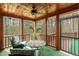 Relaxing screened-in porch with a ceiling fan, outdoor seating, providing a cozy space to enjoy nature at 932 Gynnis Creek Dr, Moncure, NC 27559