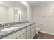 Bathroom features a dual sink granite vanity with a large mirror and wood-look flooring at 104 Burnello Ct, Princeton, NC 27569