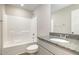 Bright bathroom features a granite-topped sink and a tub-shower with a white tile surround at 104 Burnello Ct, Princeton, NC 27569