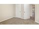 Neutrally decorated bedroom with carpeted floor and a closet on the left and right at 104 Burnello Ct, Princeton, NC 27569