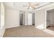 Comfortable bedroom with neutral carpeting, tray ceiling, and ensuite bathroom access at 104 Burnello Ct, Princeton, NC 27569