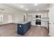 Open-concept kitchen featuring a large island, white cabinets, and stainless steel appliances at 104 Burnello Ct, Princeton, NC 27569