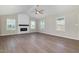 Bright living room featuring a fireplace, ample natural light, and vaulted ceiling at 104 Burnello Ct, Princeton, NC 27569