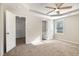 Spacious main bedroom featuring a ceiling fan, ensuite bathroom, and walk-in closet at 104 Burnello Ct, Princeton, NC 27569