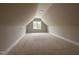 An unfinished attic with a window providing natural light at 104 Roma Gora Ct, Princeton, NC 27569