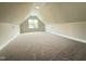 Attic space featuring plush carpeting and a dormer window, creating a bright and cozy atmosphere at 104 Roma Gora Ct, Princeton, NC 27569