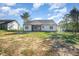 Home exterior featuring a screened porch and a spacious backyard ideal for outdoor activities at 104 Roma Gora Ct, Princeton, NC 27569