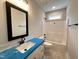 Bathroom featuring blue countertop, white cabinets and tub at 104 Roma Gora Ct, Princeton, NC 27569