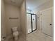 Bright bathroom with a shower, toilet and dark hardware and fixtures at 104 Roma Gora Ct, Princeton, NC 27569