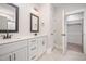 Bathroom with double sink vanity, black hardware, and walk in closet at 104 Roma Gora Ct, Princeton, NC 27569