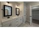 Elegant bathroom features double vanities, black hardware and a closet door at 104 Roma Gora Ct, Princeton, NC 27569