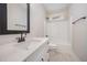 The bright bathroom features a vanity, framed mirror, and shower with tub at 104 Roma Gora Ct, Princeton, NC 27569