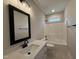 Clean bathroom features white cabinets, quartz counters and dark hardware and fixtures at 104 Roma Gora Ct, Princeton, NC 27569