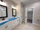 Bathroom featuring double sinks with white cabinets and an open closet at 104 Roma Gora Ct, Princeton, NC 27569